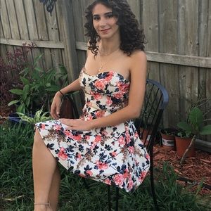 A dress with floral print, strapless, short.